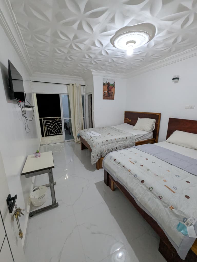 Room with large window and dusk skyline