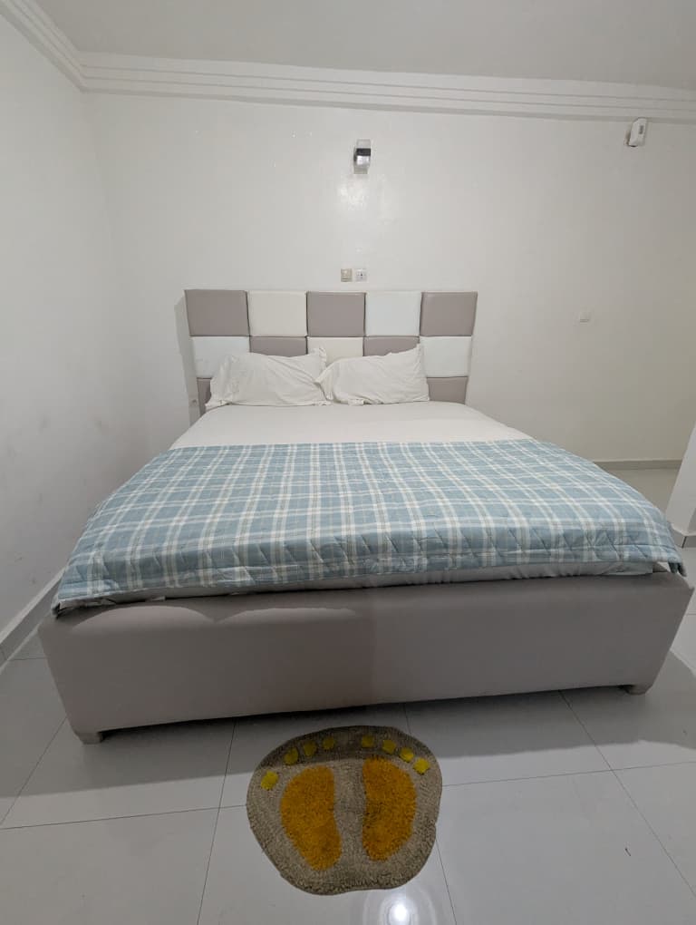 Deluxe King Room with beige sheets and warm lighting